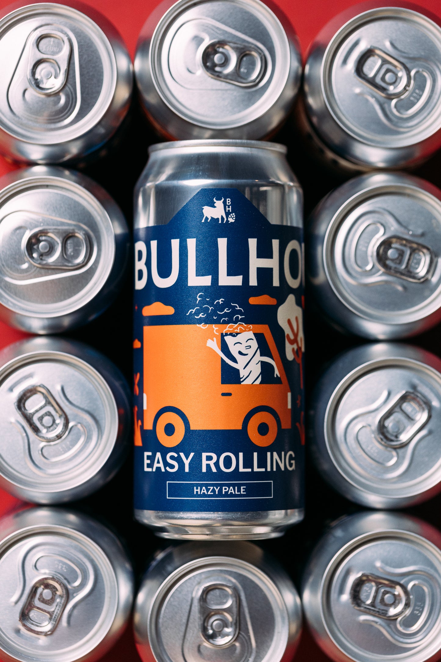
                  
                    Bullhouse Easy Rolling beer can surrounded by silver beer cans on a red background
                  
                