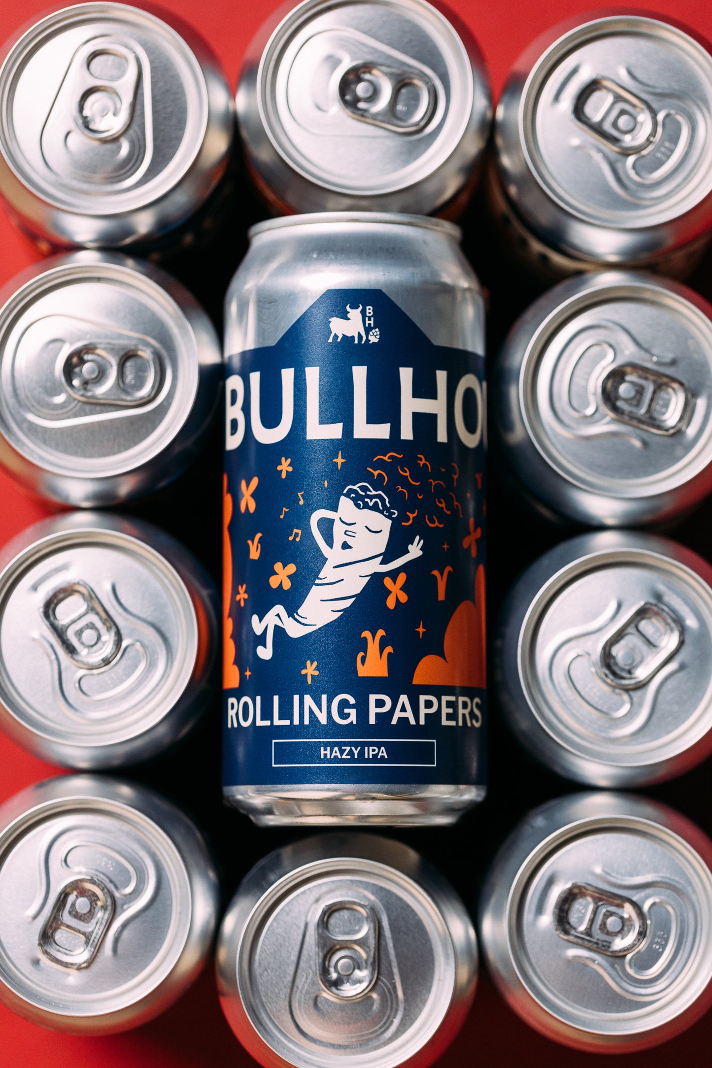 
                  
                    Bullhouse Rolling Papers can surrounded by silver cans on a red background
                  
                